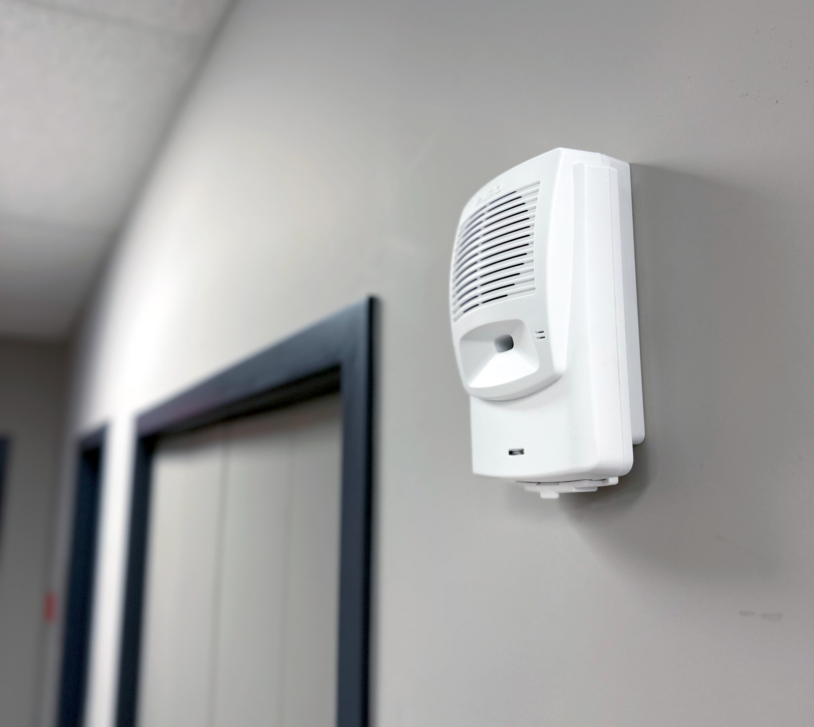 Image of Algo 8180 Audio Alerter mounted on a wall in a hallway for loud alerting.